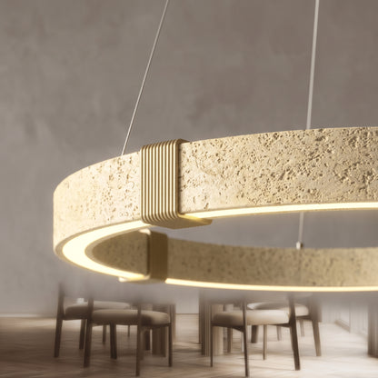Close-up of the Torvi chandelier's travertine texture and brass clamp