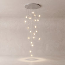 Astra crystal staircase chandelier on a warm light grey studio background