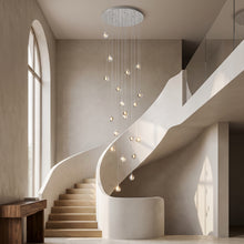 Astra silver crystal staircase chandelier cascading in a double-height stairwell
