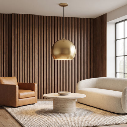 Vesper gold globe pendant light in a living room with a walnut slat wall