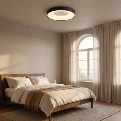 Alaric matte black round flush mount ceiling light in a bedroom