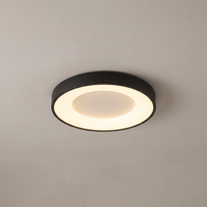 Alaric round flush mount ceiling light in matte black on a grey ceiling