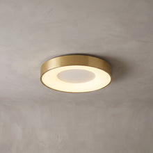Alaric round flush mount ceiling light in brushed gold on a grey ceiling