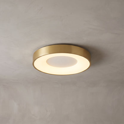 Alaric round flush mount ceiling light in brushed gold on a grey ceiling