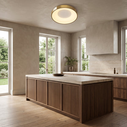 Alaric gold round flush mount ceiling light above a walnut kitchen island