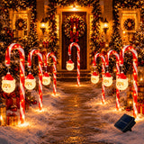 Candy cane stake lights set out along a front path at night