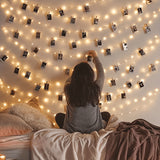 Photo wall lights arranged on a bedroom wall