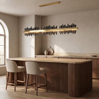 Cascade linear chandelier in jet black above a walnut kitchen island