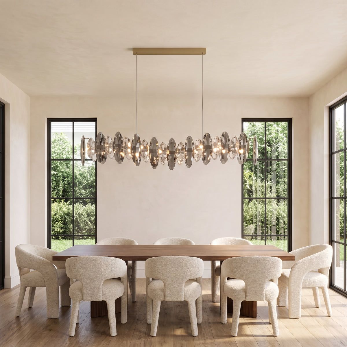 Celestial gold crystal pendant light above a long walnut dining table