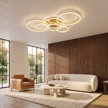 Ondine gold LED circle ring flush mount ceiling light with six rings in a living room with walnut slat wall