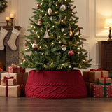 Red knit tree collar around a decorated Christmas tree