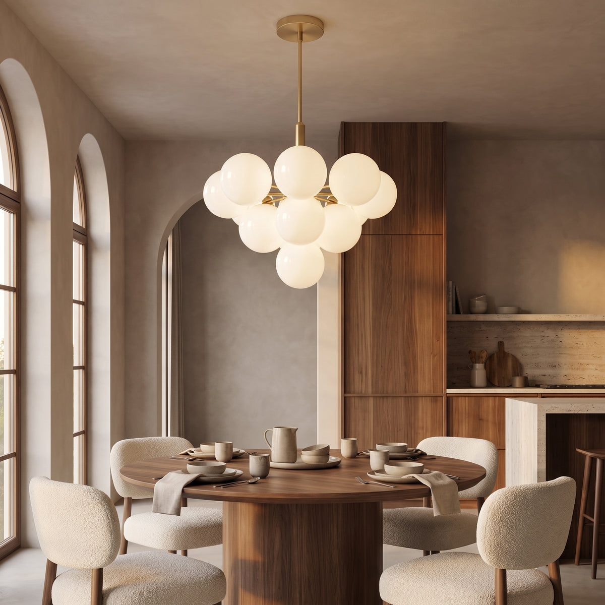 Solenne Pendant 13-light gold globe cluster above a round walnut dining table