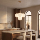 Solenne Pendant 5-light globe cluster above a walnut kitchen island
