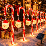 Solar candy cane pathway lights with hanging Santa ornaments lining a walkway