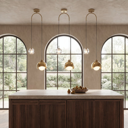 Three Noor dual pendant lights above a walnut kitchen island