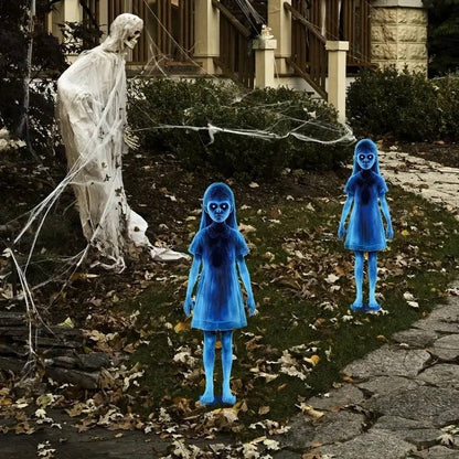 Two Halloween ghost stakes placed near a patio