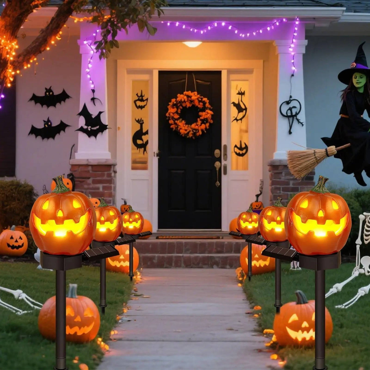Solar pumpkin pathway lights glowing at night along a walkway