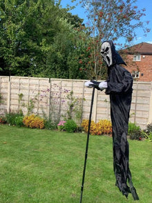 Hooded ghost figure in a full-length black robe