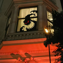 White ghost window decoration with red eyes