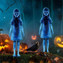 Two ghost yard stakes staked into a lawn for Halloween