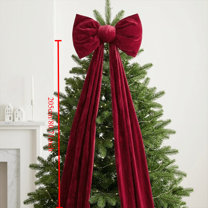 Long tailed red velvet bow for a fireplace, staircase or window