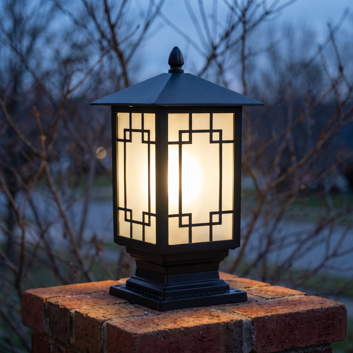 Elmwood post light glowing through lattice frosted glass at November dusk