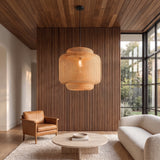 Maren woven bamboo pendant in a living room with a walnut slat wall