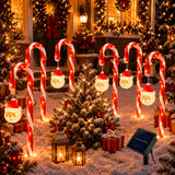 Hanging Santa ornament detail on a candy cane stake light