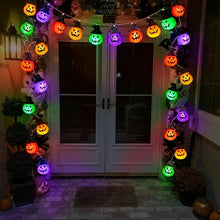 Multicolor pumpkin bead string light strand coiled on a white background