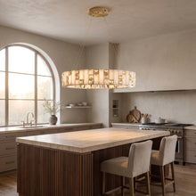 Halcyon alabaster and gold ring chandelier above a walnut kitchen island