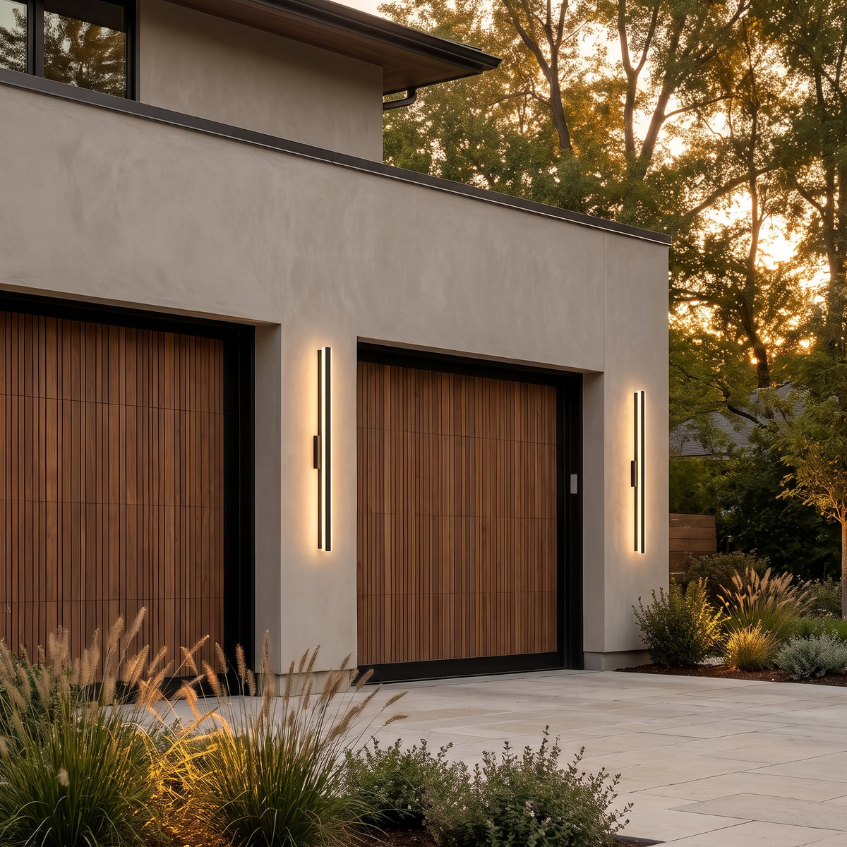 Haylen linear LED wall light beside a modern garage at dusk