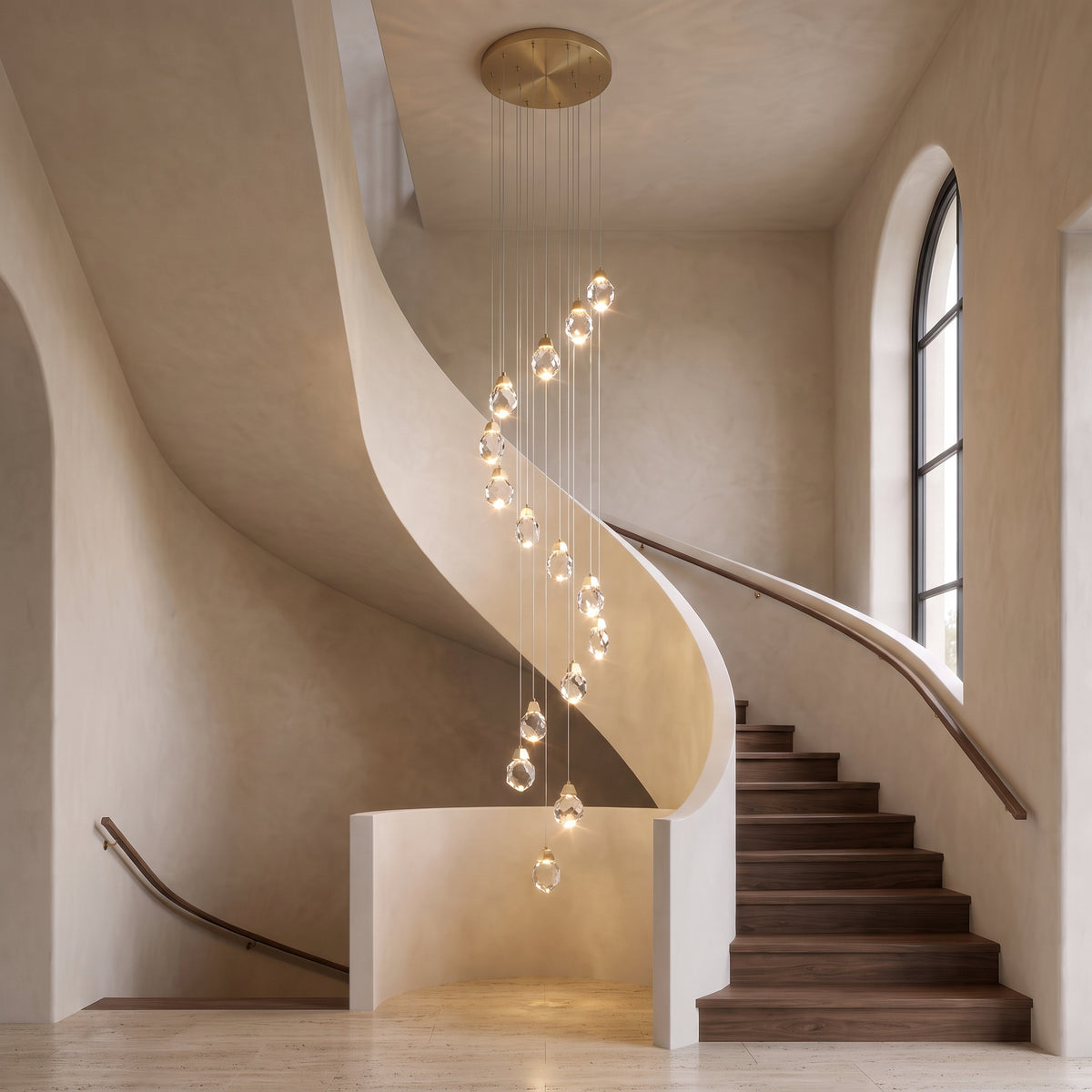 Alaric crystal chandelier cascade centered in an elegant curved stairwell