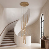 Aurelia cascading gold chandelier centered in an elegant curved stairwell