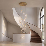 Hailstone crystal chandelier cascade centered in an elegant curved stairwell