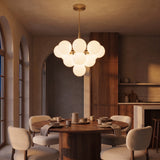 Solenne Pendant globe cluster at night — lights on