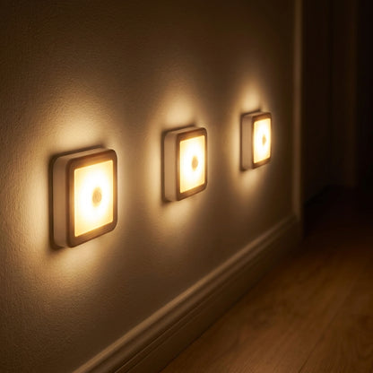 Hotaru Motion Sensor LED Night Light - Warm White, 3-pack glowing warmly in hallway at night