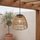 Havana rattan solar pendant lantern glowing under a pergola
