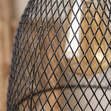 Close-up of the black iron mesh weave with warm glow