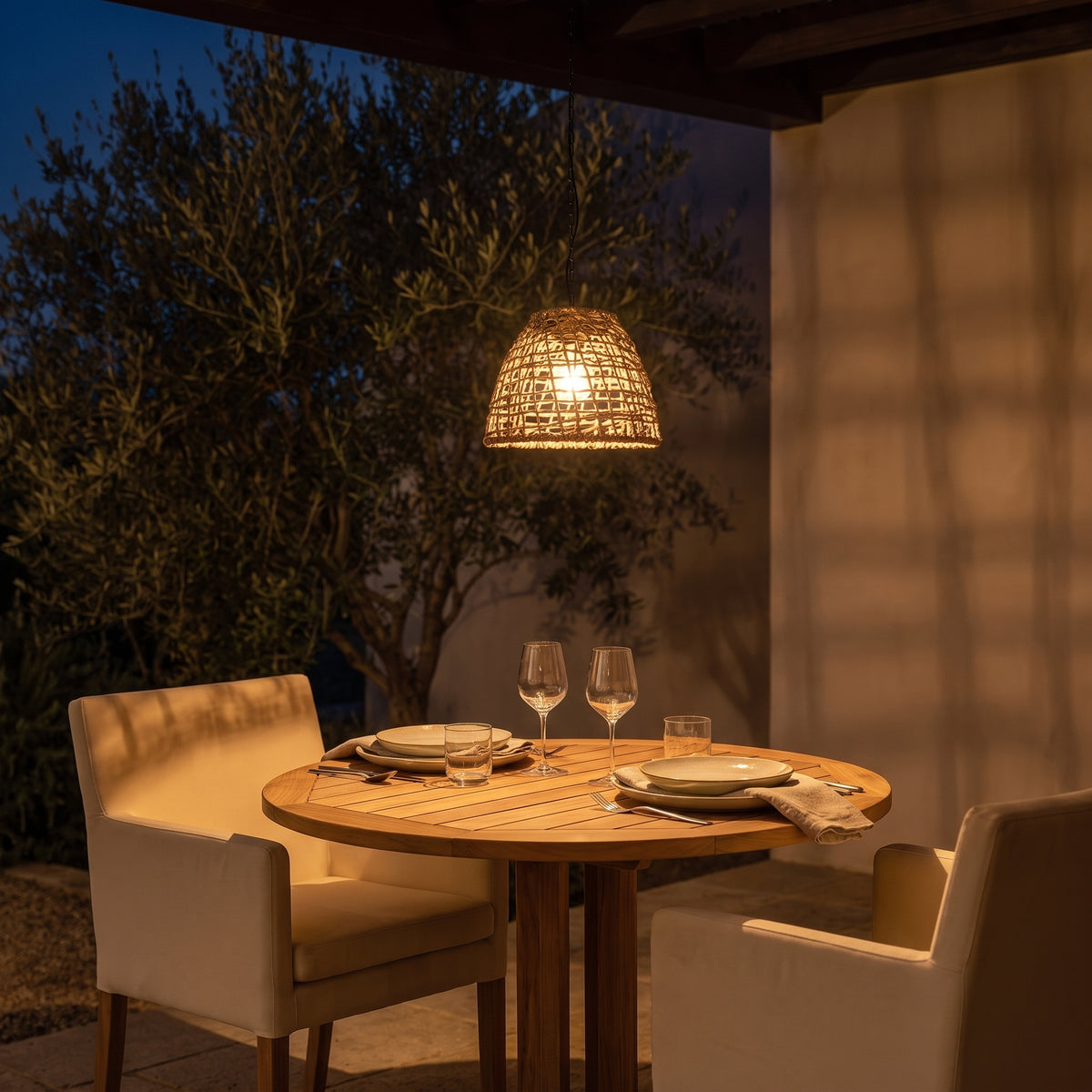 Havana rattan solar lantern glowing above a bistro table at night