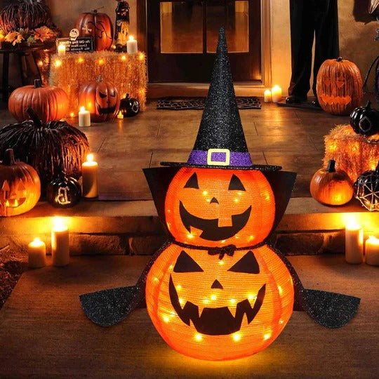 Lit pumpkin decorations glowing on a porch step at night