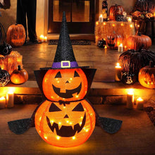 Two illuminated 3 ft collapsible Halloween pumpkin decorations glowing outdoors at night