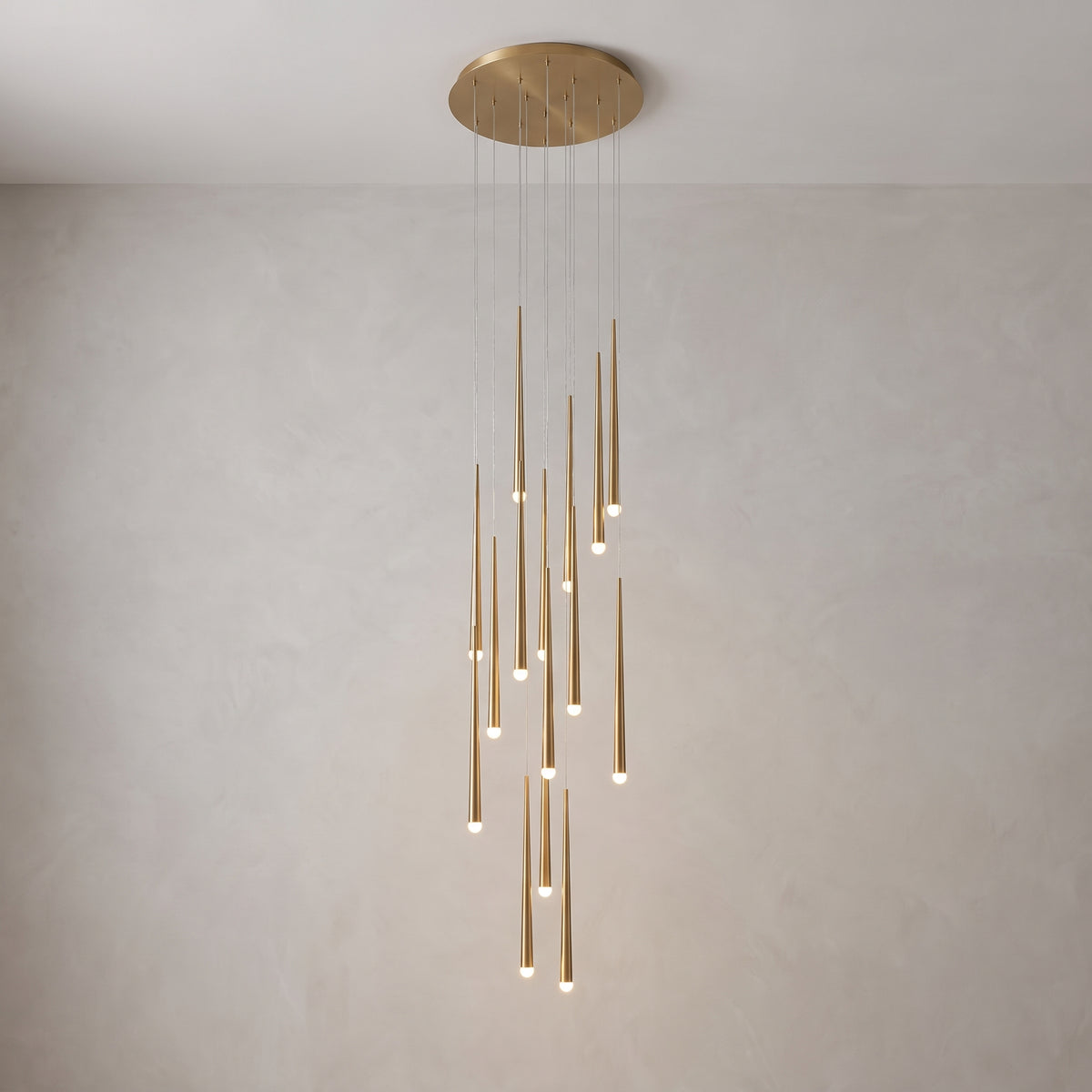 Full cascading chandelier shown against a plain grey studio background