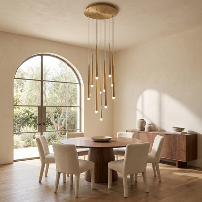 Cascading chandelier hanging above a round walnut dining table