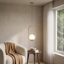 Opaline brushed gold hoop pendant with opal globe in a reading corner