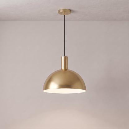 Isolde brass dome pendant light in brushed gold on a grey studio background