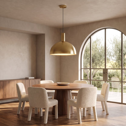Isolde brushed gold brass dome pendant light above a round walnut dining table