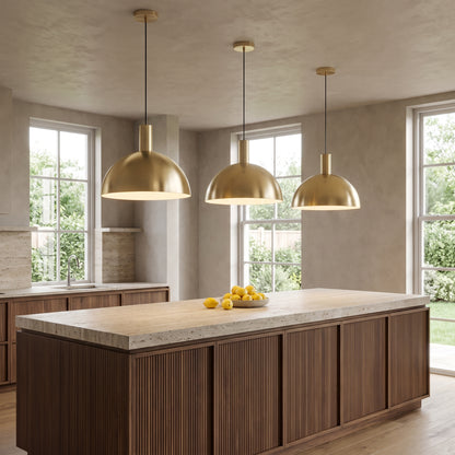 Three Isolde brass dome pendant lights in gold above a walnut kitchen island