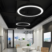 LED ring pendant light with white acrylic shade in an office