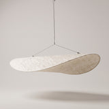 Kinu silk fabric pendant light on a warm grey studio background