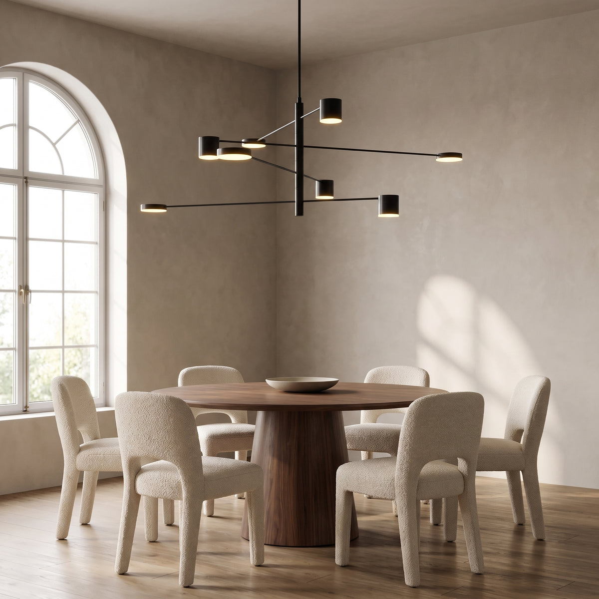 Lynx modern chandelier in black ash above a round walnut dining table
